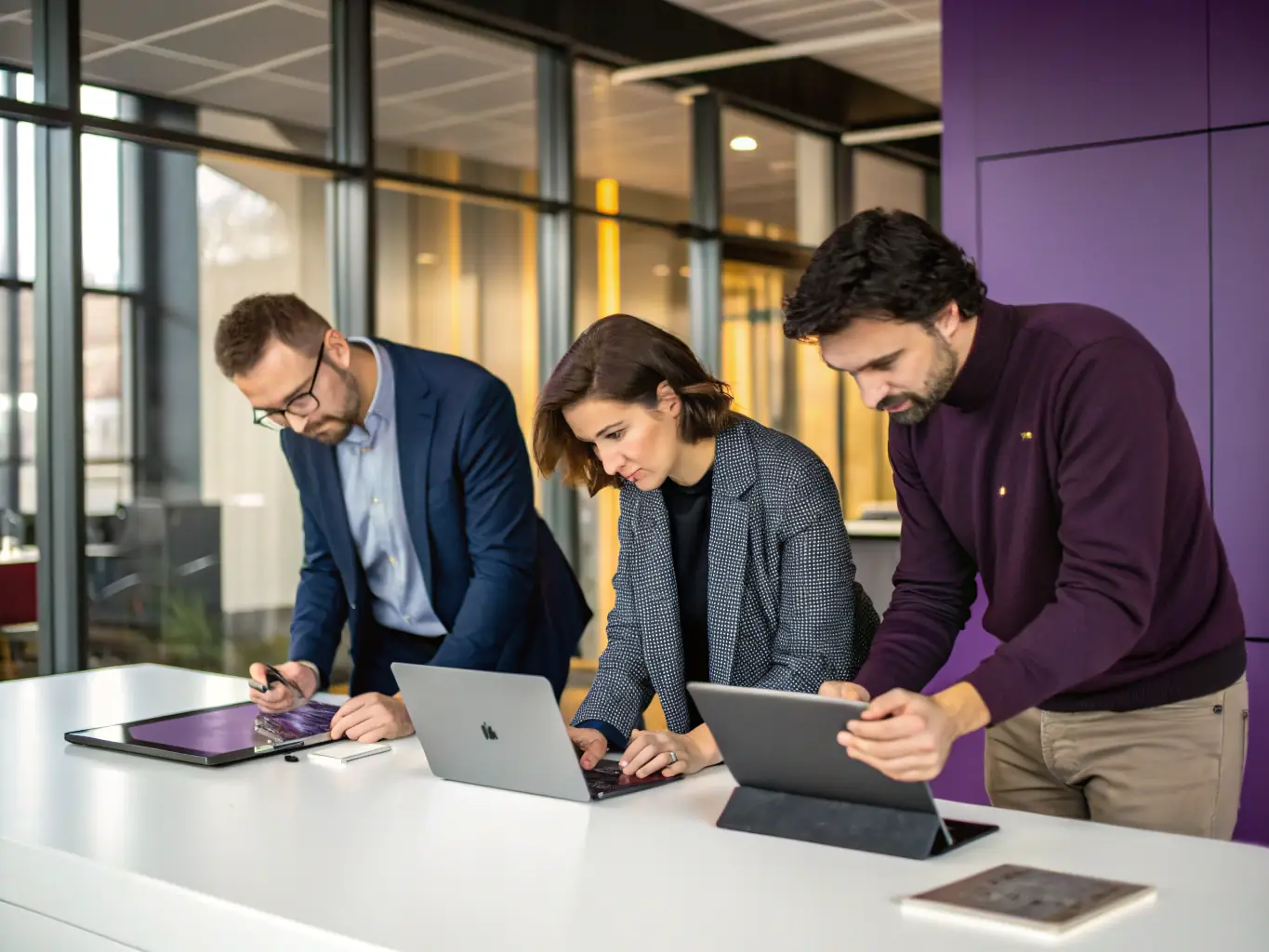 A team of AtlasCare IT technicians is shown deploying new laptops in a corporate environment, illustrating the rollout management service.